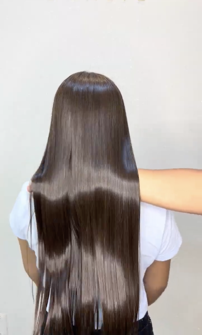 Cabelo liso marrom longo exibido de costas após alisamento